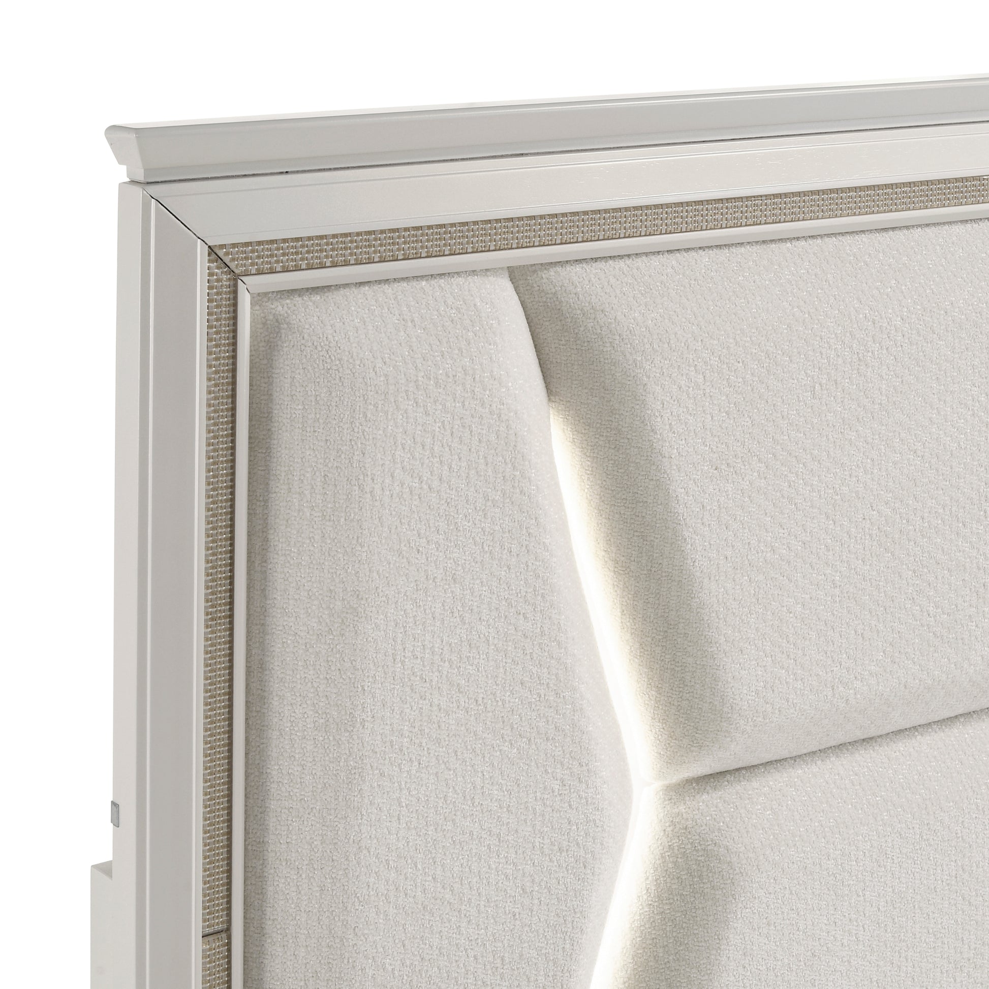 Close-up of the Audra Collection headboard featuring a white panel design with gold trim accents and modern acrylic post legs – available at Paty Furniture in Tacoma, Kent, and Burien.