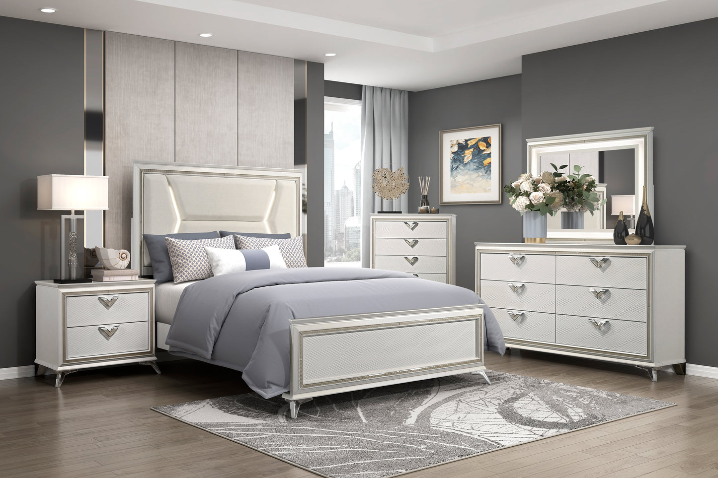 Audra Collection modern glam bedroom set in white and gold featuring a king bed with acrylic legs, nightstands, dresser, mirror, and chest – available at Paty Furniture in Tacoma, Kent, and Burien.