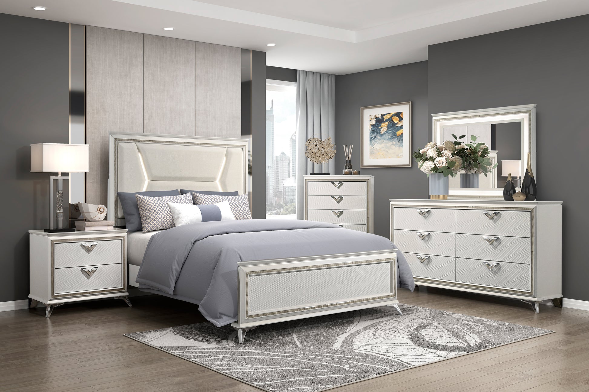Audra Collection modern glam bedroom set in white and gold featuring a king bed with acrylic legs, nightstands, dresser, mirror, and chest – available at Paty Furniture in Tacoma, Kent, and Burien.
