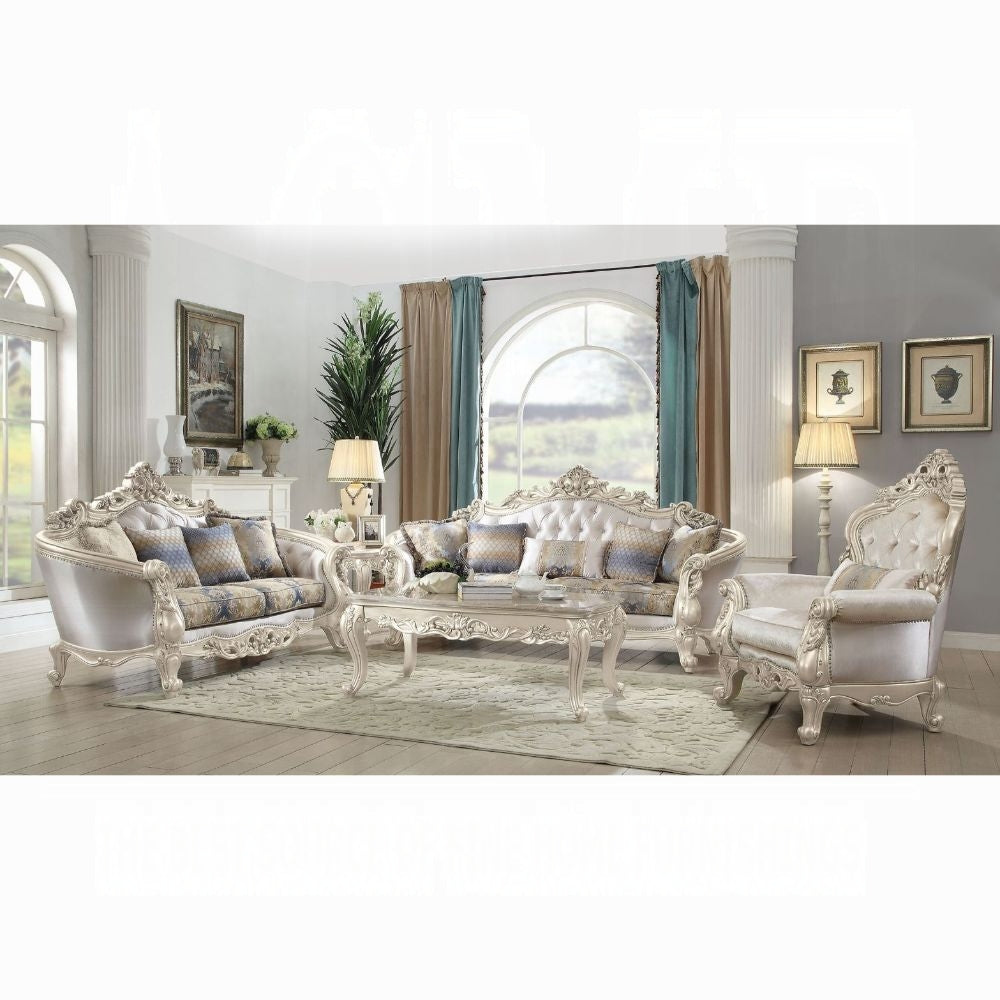 Luxurious living room with ornate white furniture set, including sofa and chairs, in a well-lit room.