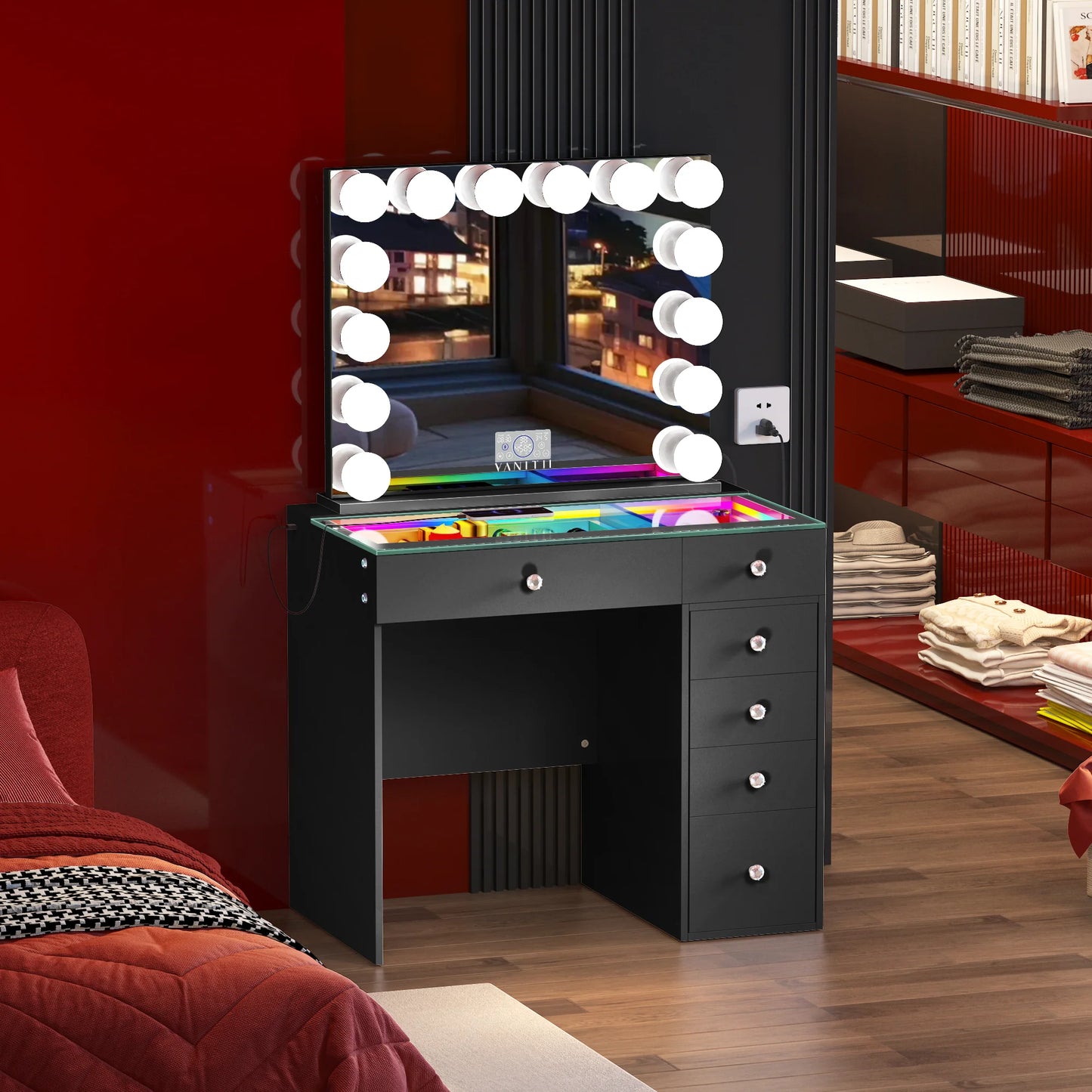 Black vanity desk with mirror and lights in a room with red walls and furniture.