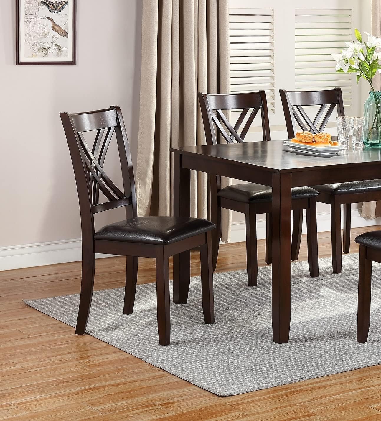 Sleek 60-inch rectangular dining table from the Eloise Collection with clean lines and a warm espresso finish, offering timeless functionality.
Eloise Collection dining chair showcasing distinctive cross-back design and cushioned faux leather seat, blending style with comfort.