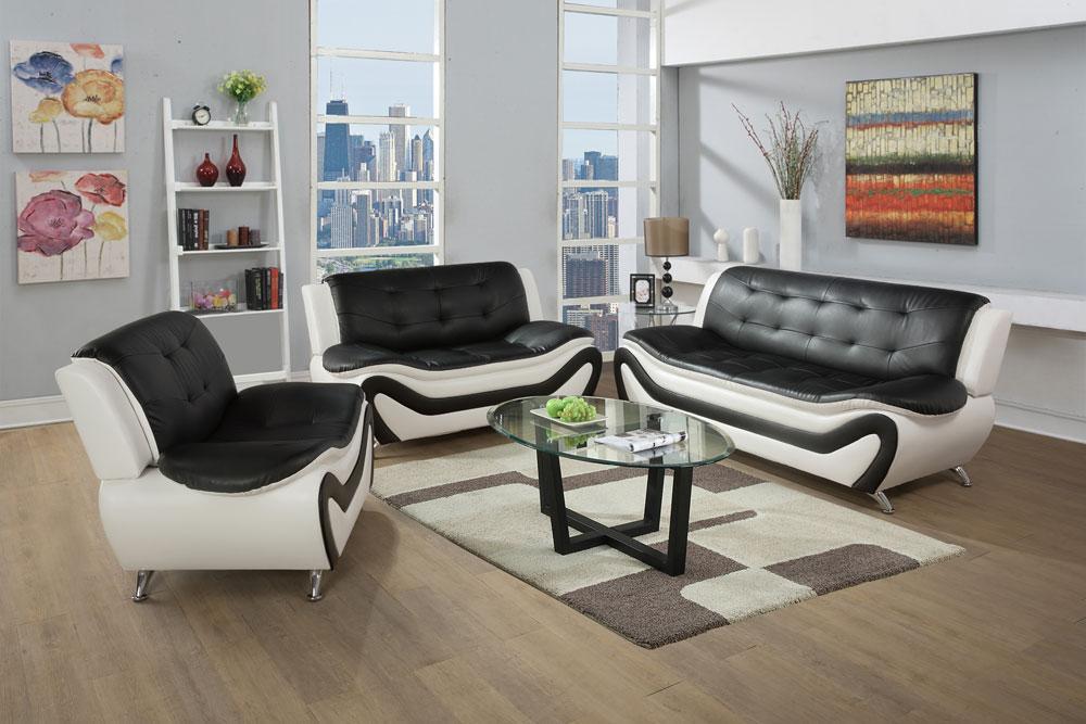 A living room set featuring a black faux leather sofa, loveseat, and chair on a wooden floor, with a glass coffee table in the foreground.