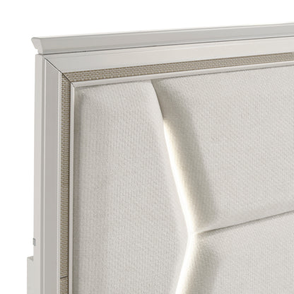 Close-up of the Audra Collection headboard featuring a white panel design with gold trim accents and modern acrylic post legs – available at Paty Furniture in Tacoma, Kent, and Burien.