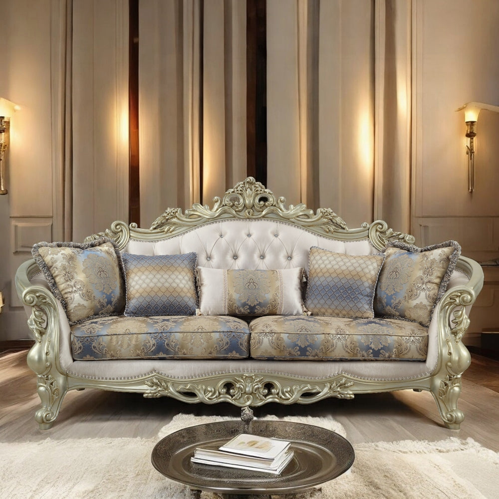 Decorative sofa with intricate carvings in a room with striped wallpaper and wall sconces.