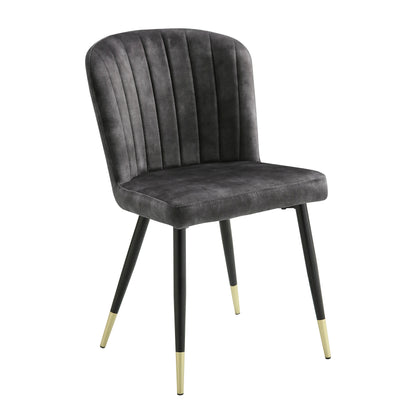 Clemente Collection dining chair with charcoal-hued velvet upholstery, channel contoured tufting, black-finished metal legs, and gold-finished tips

Detailed view of the Clemente Collection dining chair's channel tufting and gold-finished leg tips, emphasizing its refined sophistication – available at Paty Furniture in Tacoma, Kent, and Burien.