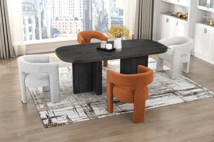 Dining room with a black round table and orange and white chairs.