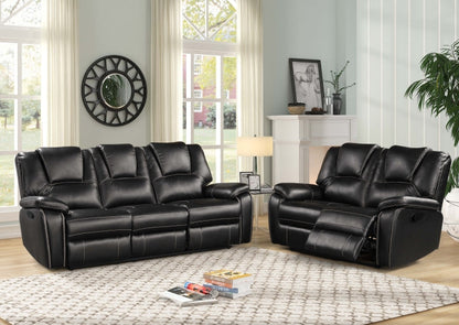 Black leather reclining sofa set in a living room setting with decor elements.