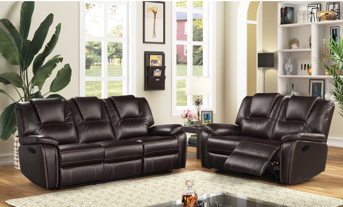 Brown leather reclining sofa and Love Seat set in a living room setting with decor elements.