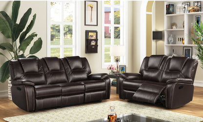 Brown leather reclining sofa and Love Seat set in a living room setting with decor elements.