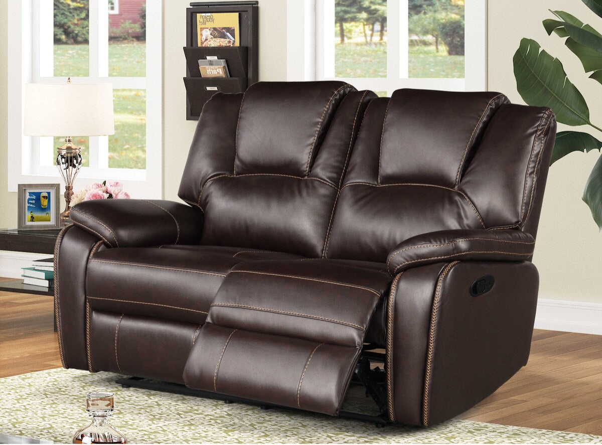 Brown leather reclining Love Seat in a living room setting with windows and decor.