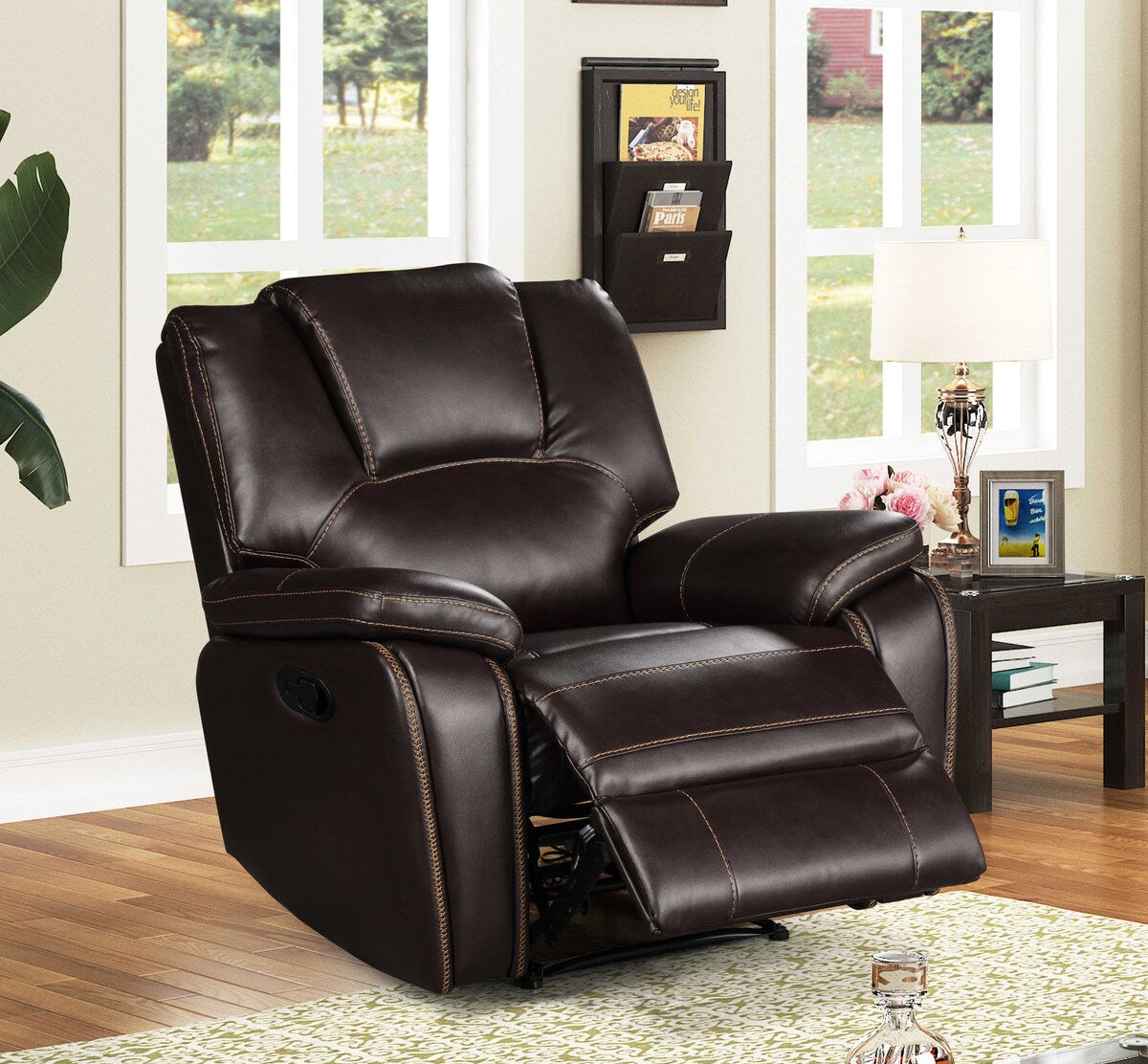 Brown leather recliner chair in a living room setting with a window and decor.