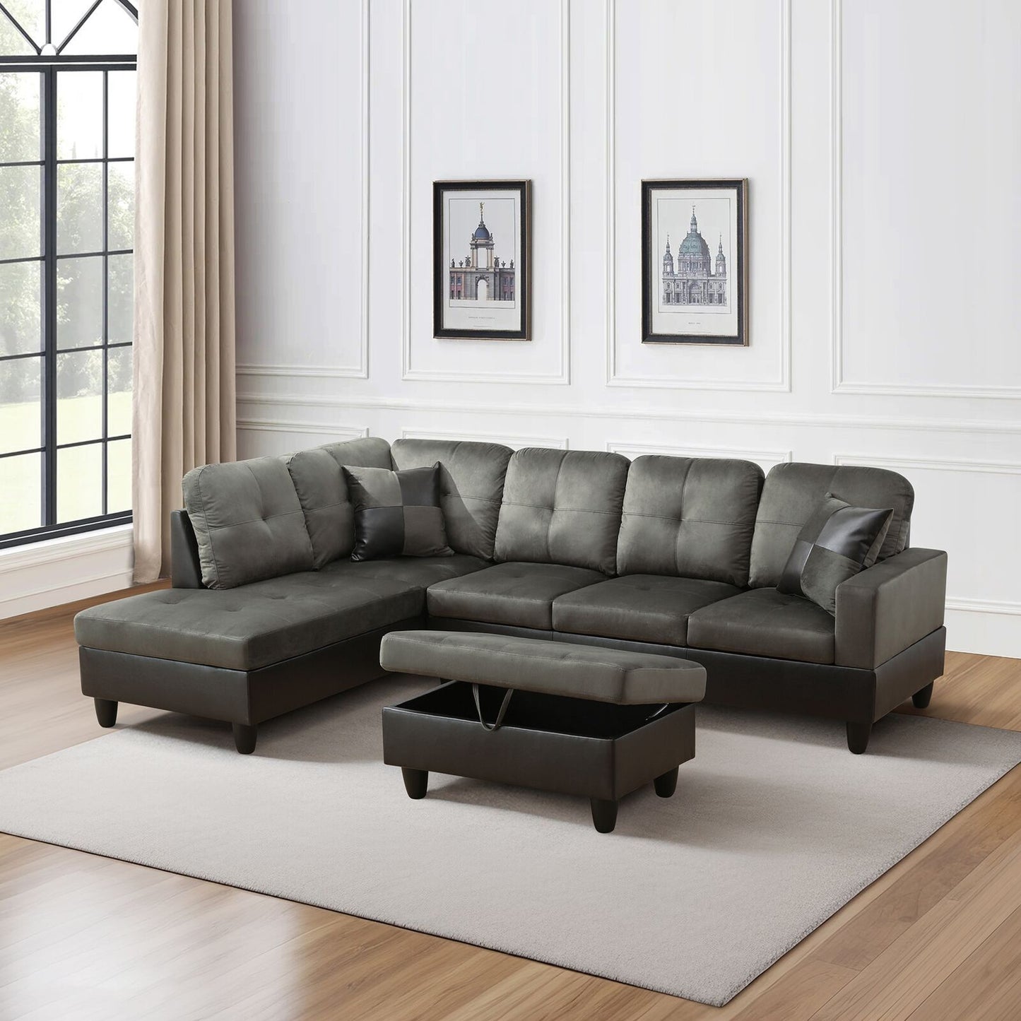 Gray sectional sofa with storage ottoman in a room with large windows and framed pictures on the wall.