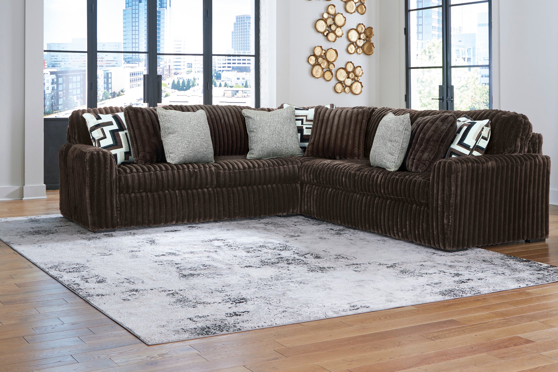 Brown sectional sofa with patterned cushions in a living room setting.