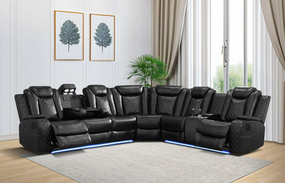 Black leather sectional sofa in a living room with light wood flooring and white walls.