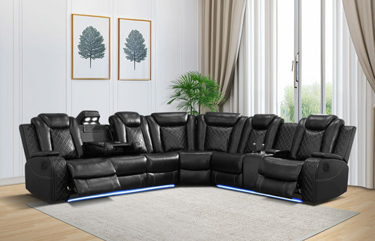 Black leather sectional sofa in a living room with light wood flooring and white walls.