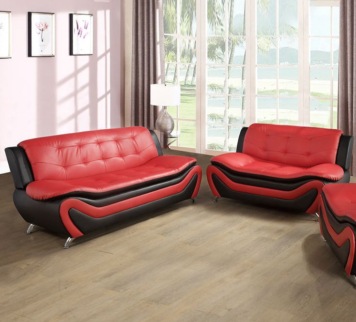 Red and black leather sofa set in a living room with large windows.