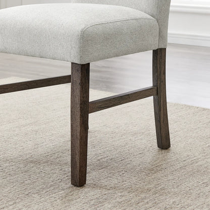 Close-up of Sorlen dining chair seat and dark wood-finish legs